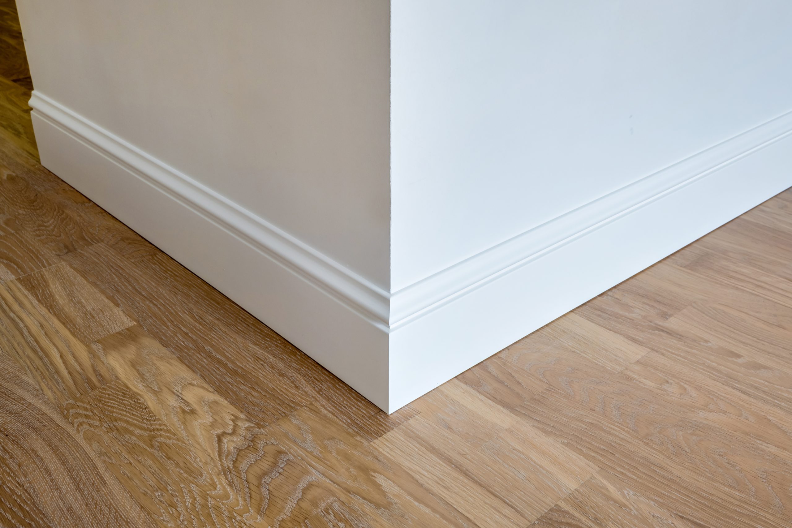 Detail of corner flooring with intricate crown molding and plint
